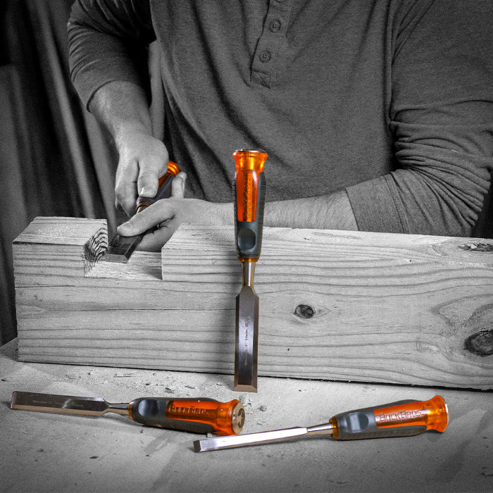 Black and white image of a couple Buck Bros chisels where only the knife is colored ornage.
